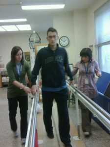 Image of Nicholas Morihovitis on day 8 of his rehab with parallel bars
