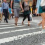 pedestrians walking across the street