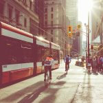 cyclist riding alongside Toronto streetcar